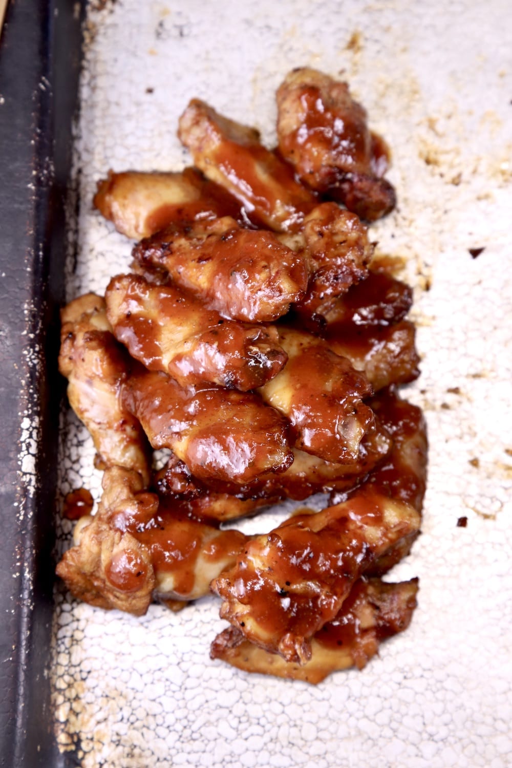 Pile of BBQ chicken wings on a sheet pan