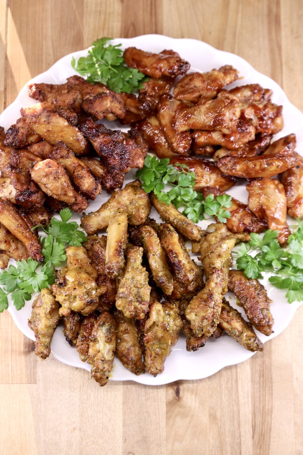 Platter of chicken wings garnished with parsley, overhead view