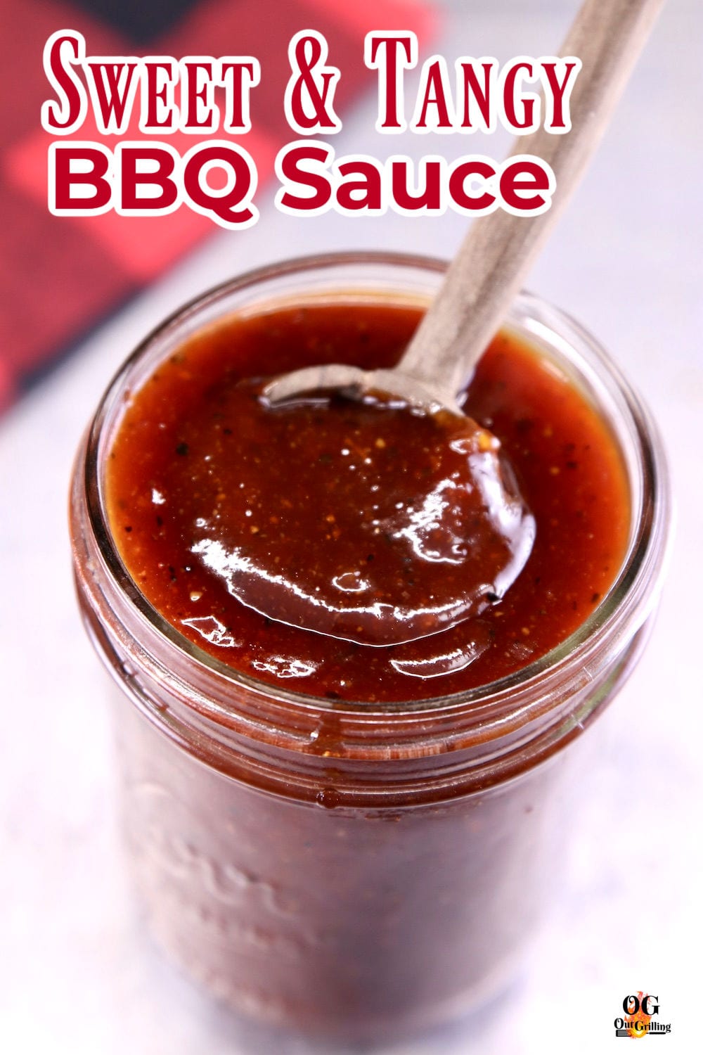 Sweet and Tangy BBQ Sauce in a jar with a spoon - text overlay for pinterest