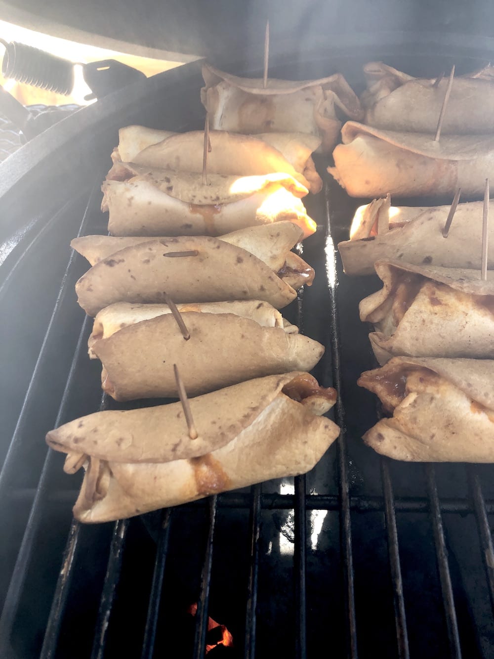 Grilled chili burritos on grill