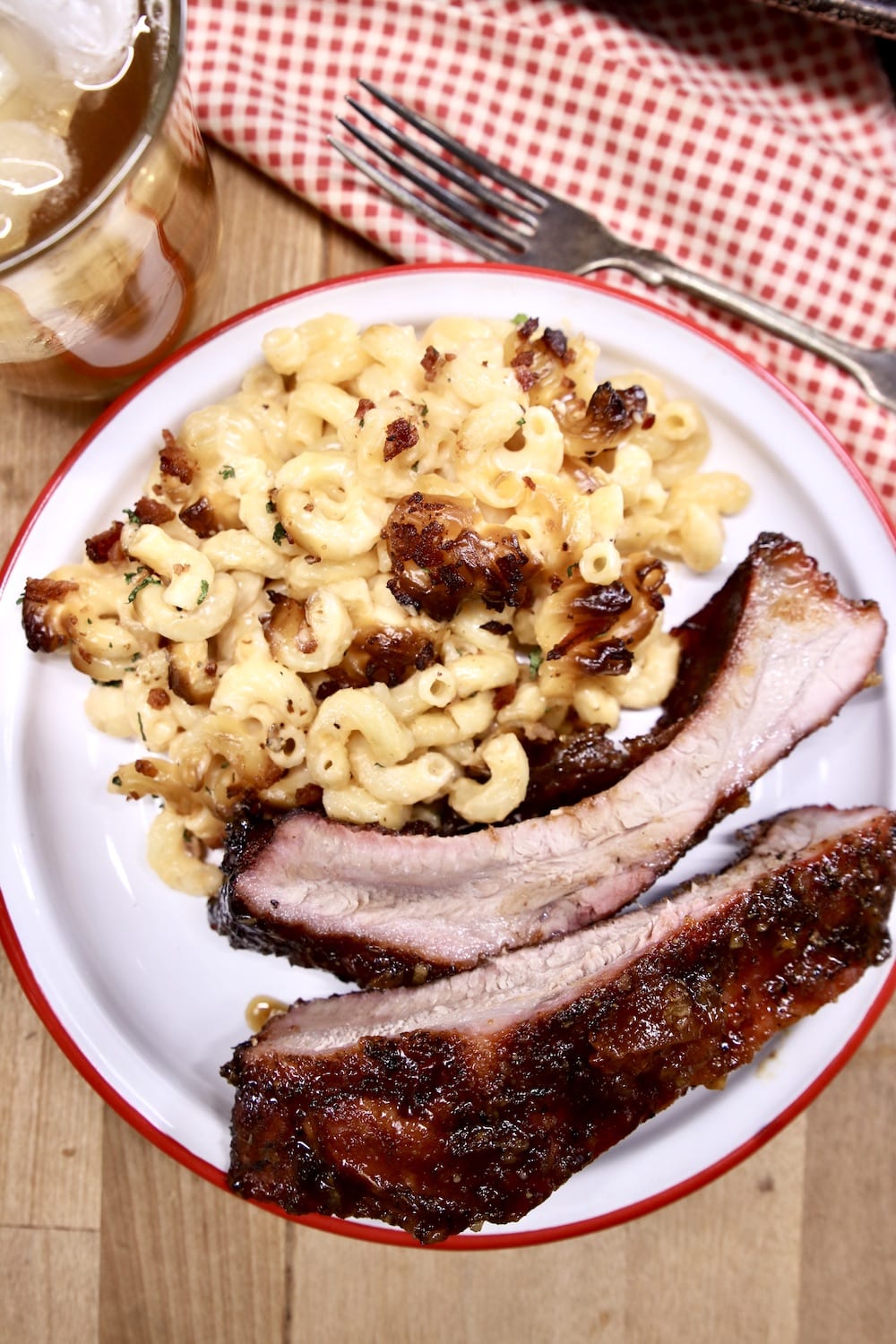 Plate of mac and cheese with 2 baby back ribs