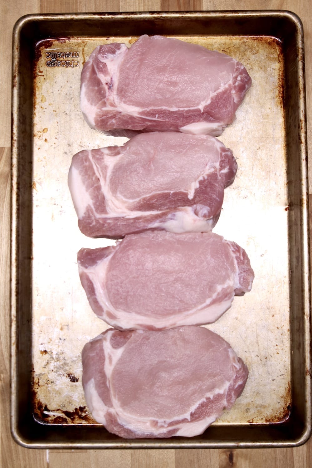 4 boneless pork chops on a sheet pan