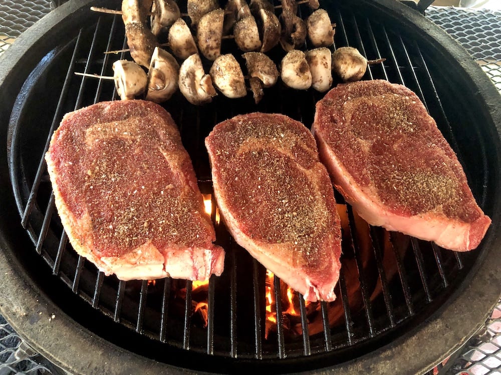 ribeye steaks on a grill