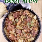 Guinness Beef Stew in a cast iron serving dish - text overlay.