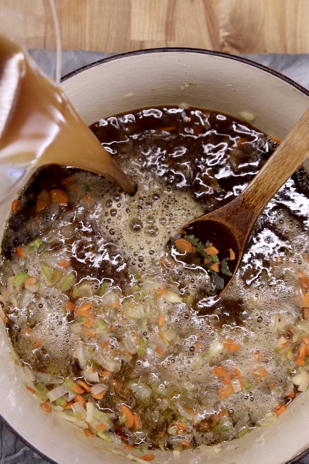 adding beef broth to soup vegetables