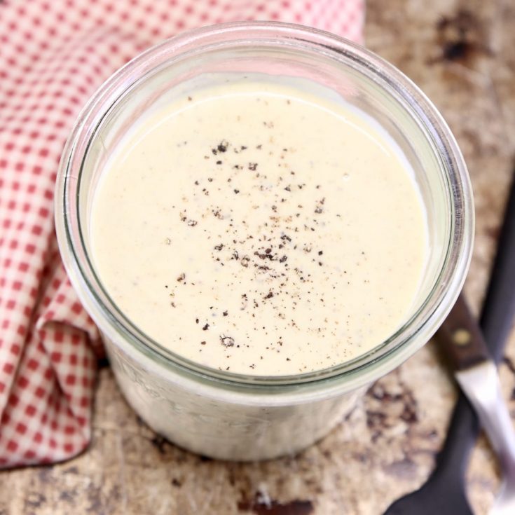 White BBQ Sauce in a jar with red check napkin