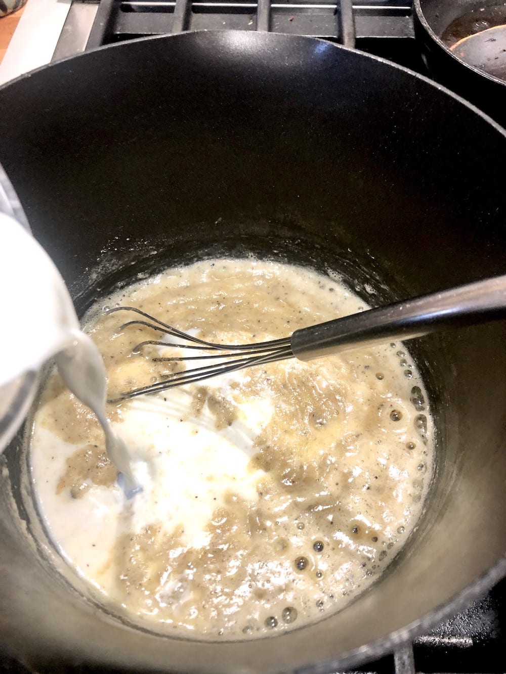 Making mac and cheese sauce - adding milk to a pan