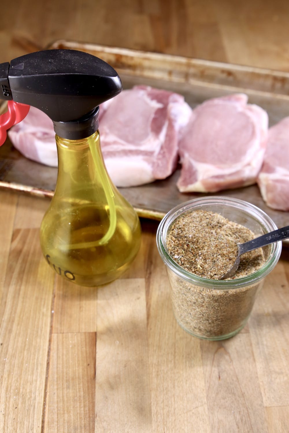 ingredients for grilled pork chops -dry rub, olive oil