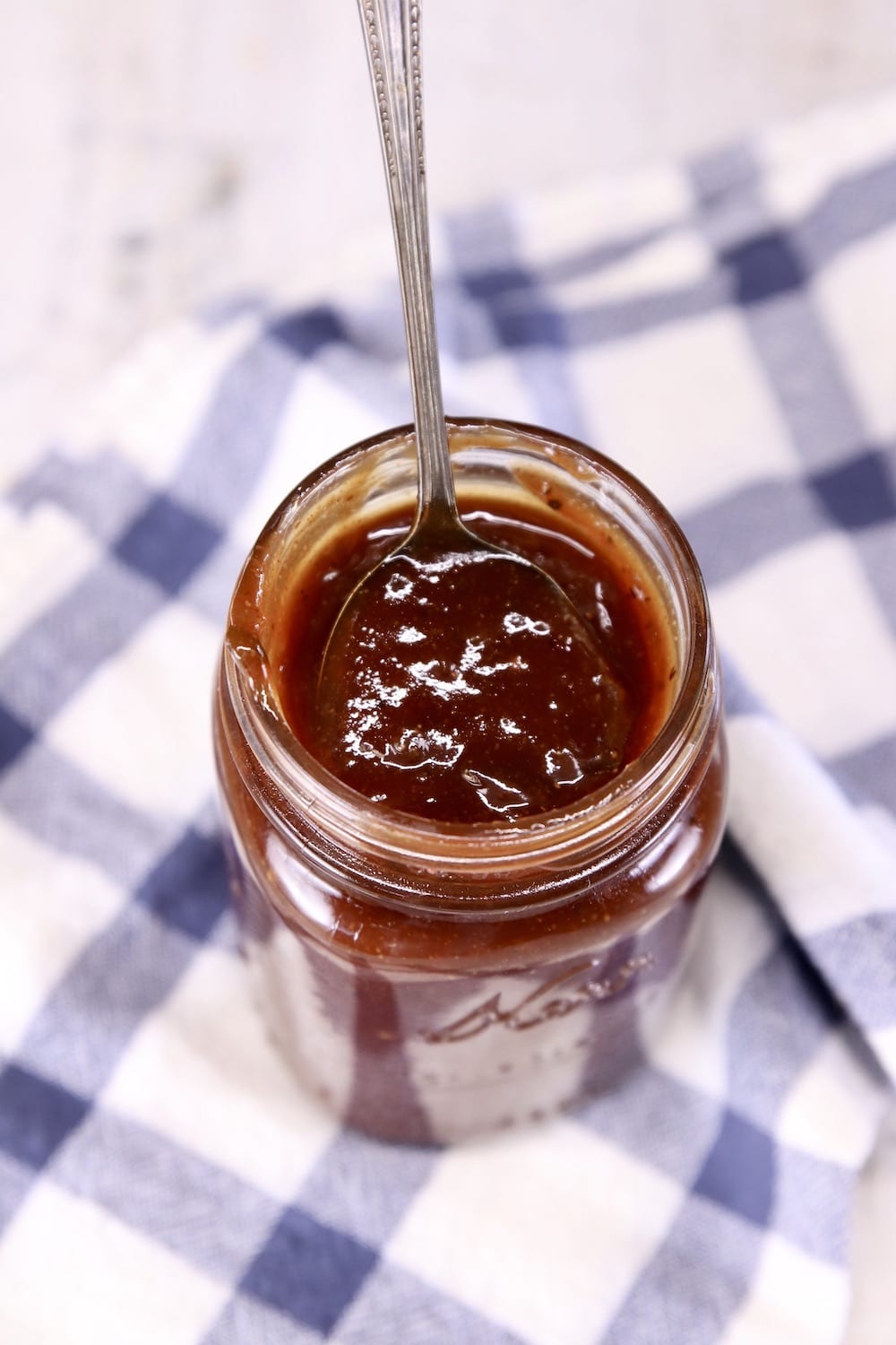 jar of bbq sauce with a spoon in it