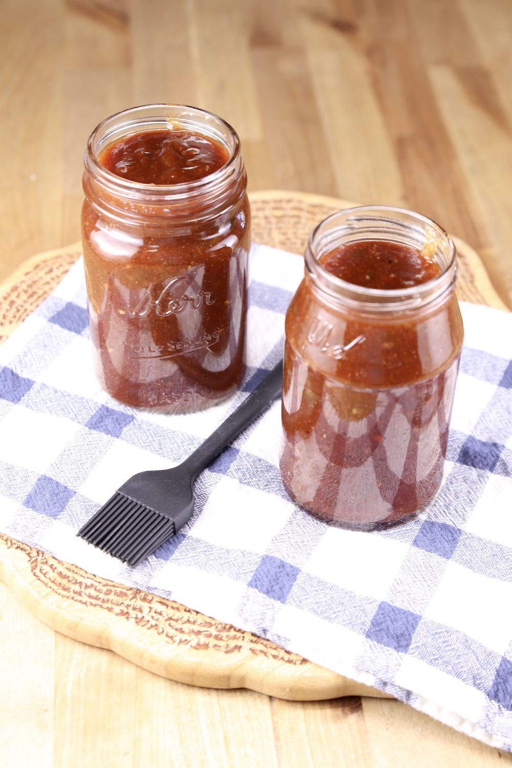 2 jars of barbecue sauce on a towel