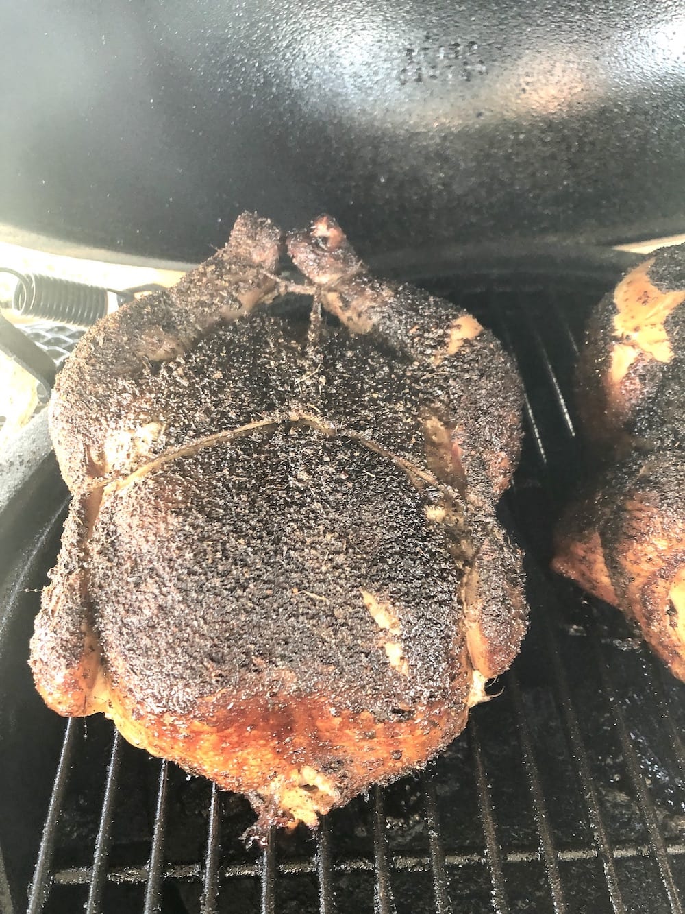 whole smoked chicken on grill
