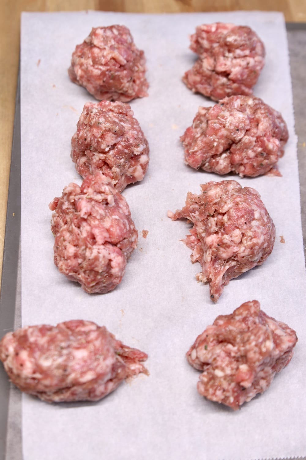 8 portions of ground sausage on parchment paper