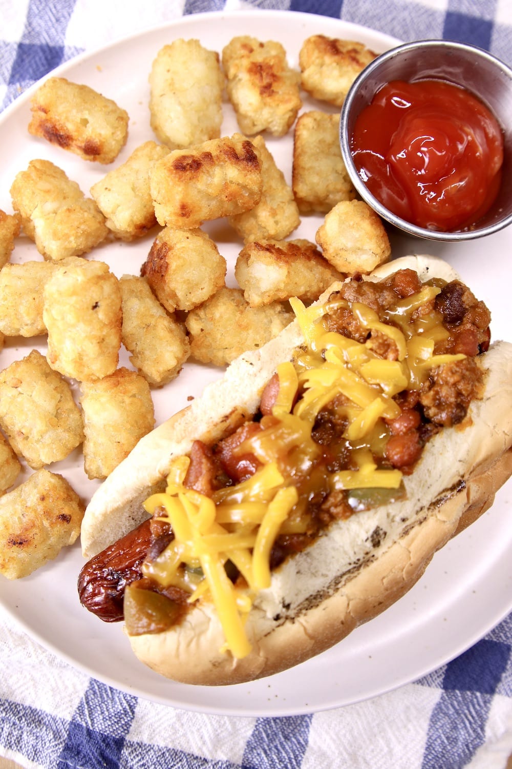 plate with chili cheese dog and tater tots