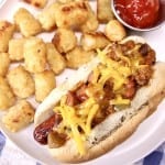 chili dog with tater tots on a plate