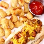Chili Dog on a plate with tater tots - text overlay
