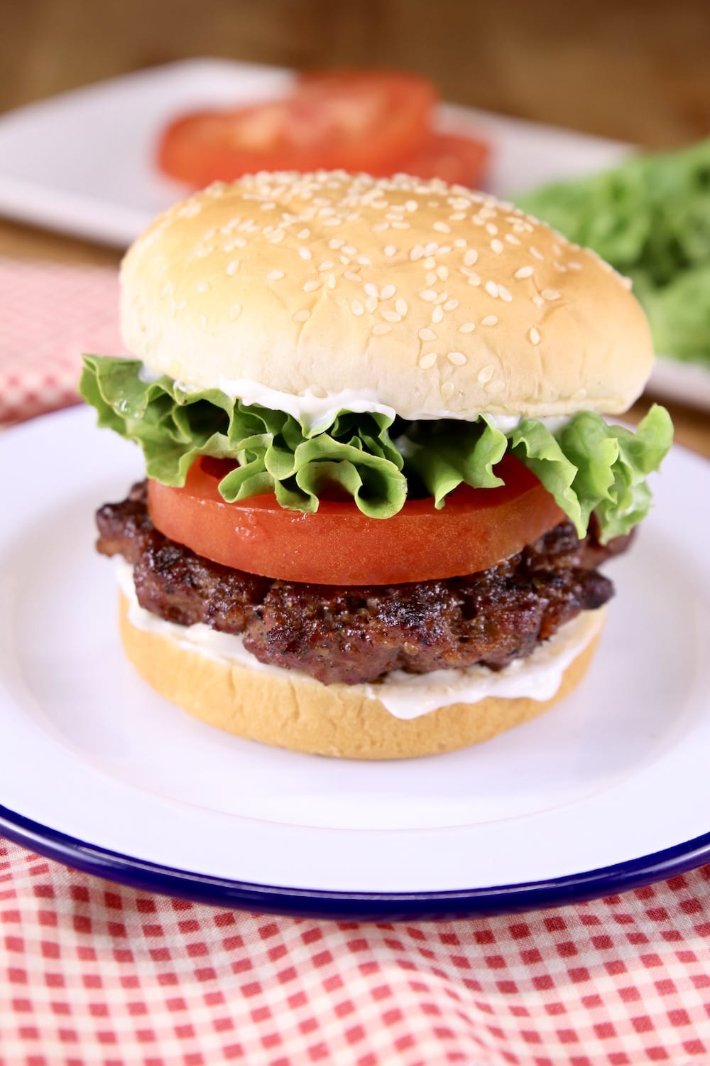 grilled brisket burger on a bun with lettuce and tomato