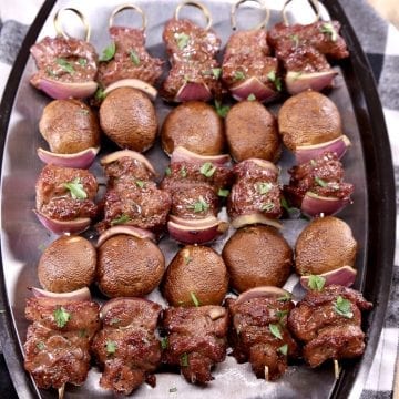 steak and mushroom kabobs on a platter