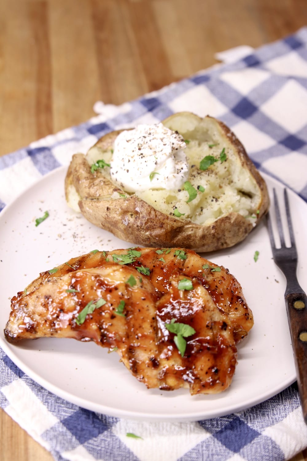 chicken tenders on a plate with baked potato