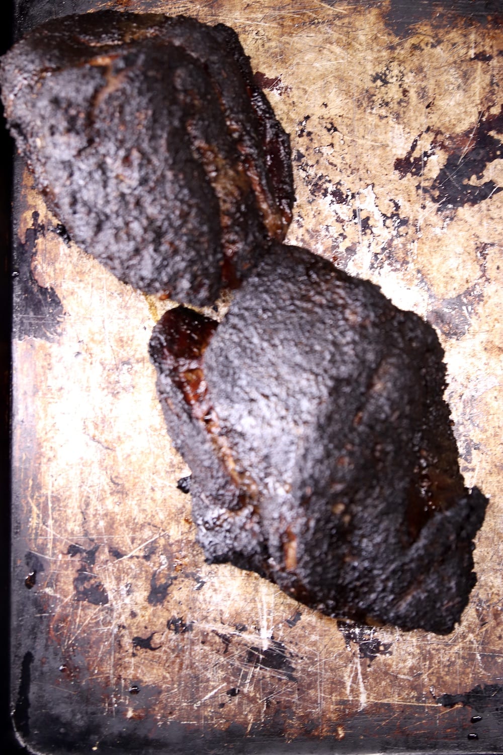 2 smoked pork shoulder roasts on a sheet pan