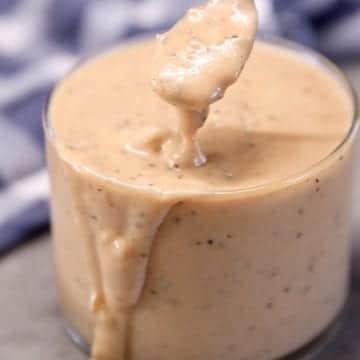burger sauce in a jar, small spoon dipping the sauce