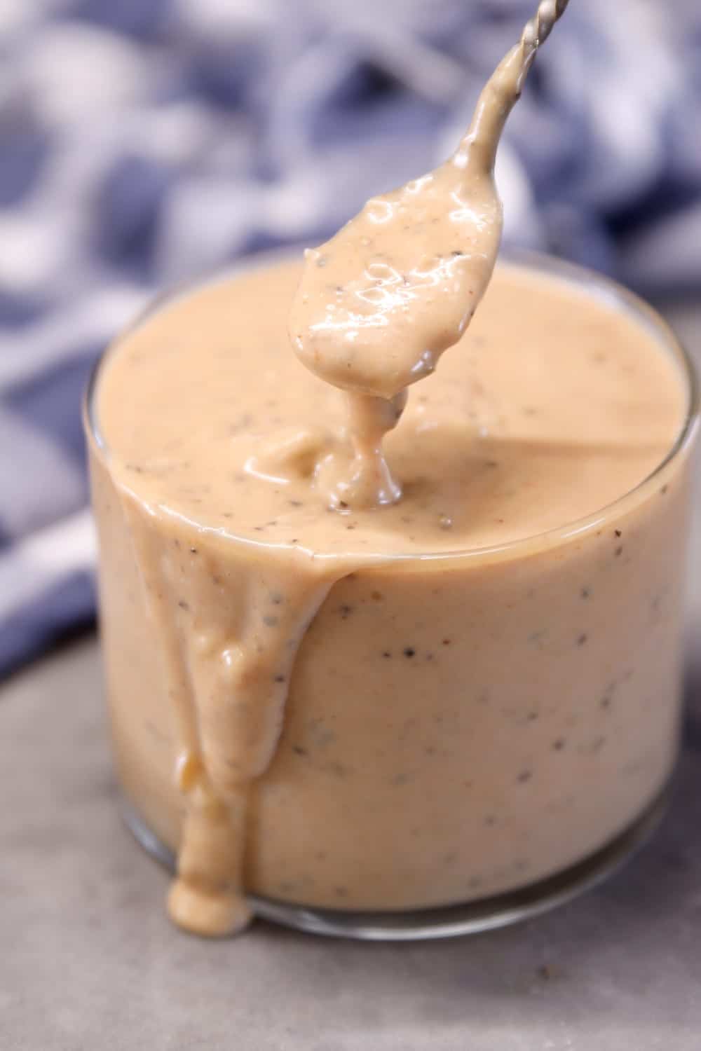 Burger Sauce in a jar with a spoon dipping the sauce