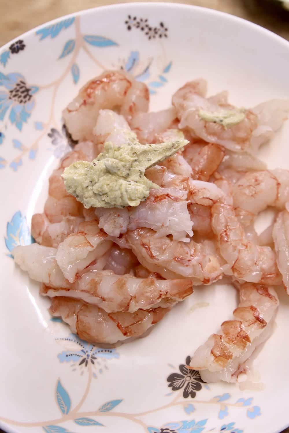 peeled shrimp in a bowl with a dollop of butter