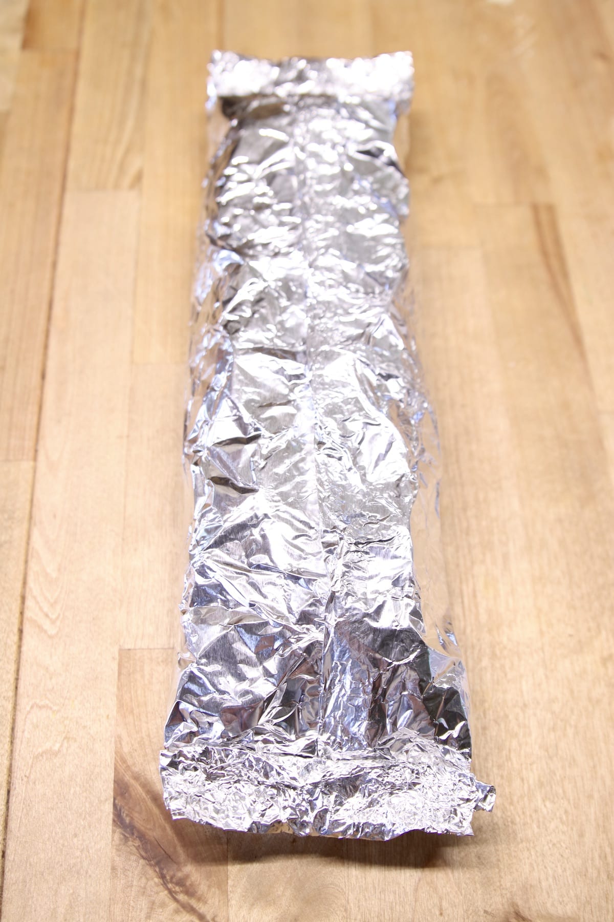 long foil packet filled with potatoes