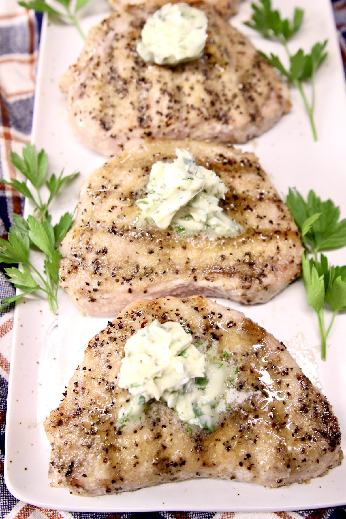 3 Grilled pork chops topped with garlic butter