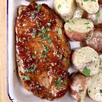 Barbecue Pork chop on a platter with red potatoes