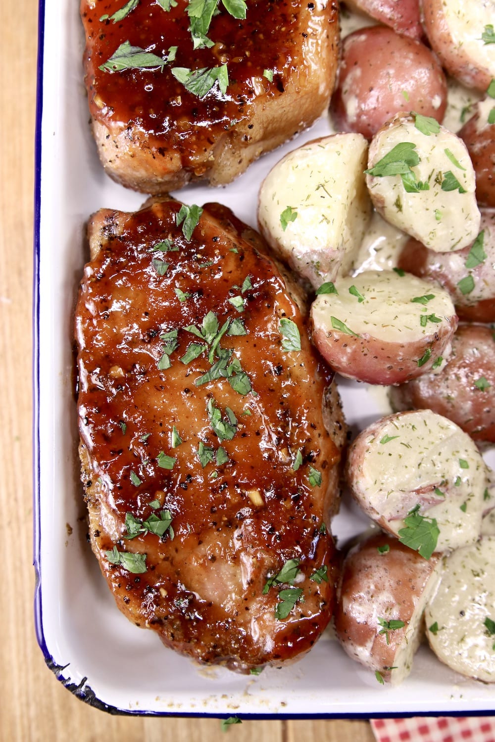 Barbecue pork chops on a platter with potatoes