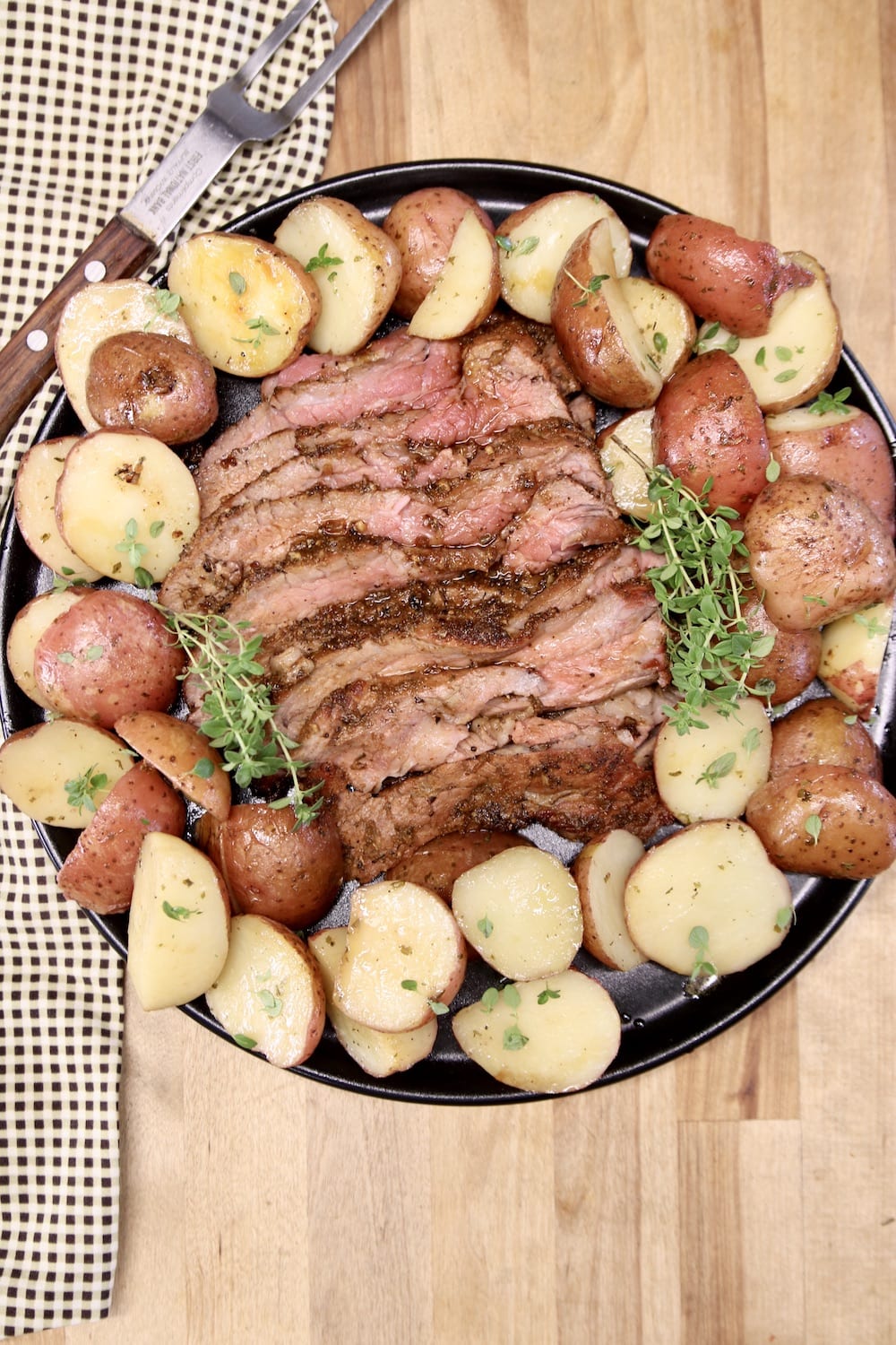 round platter with sliced steak & baby potatoes