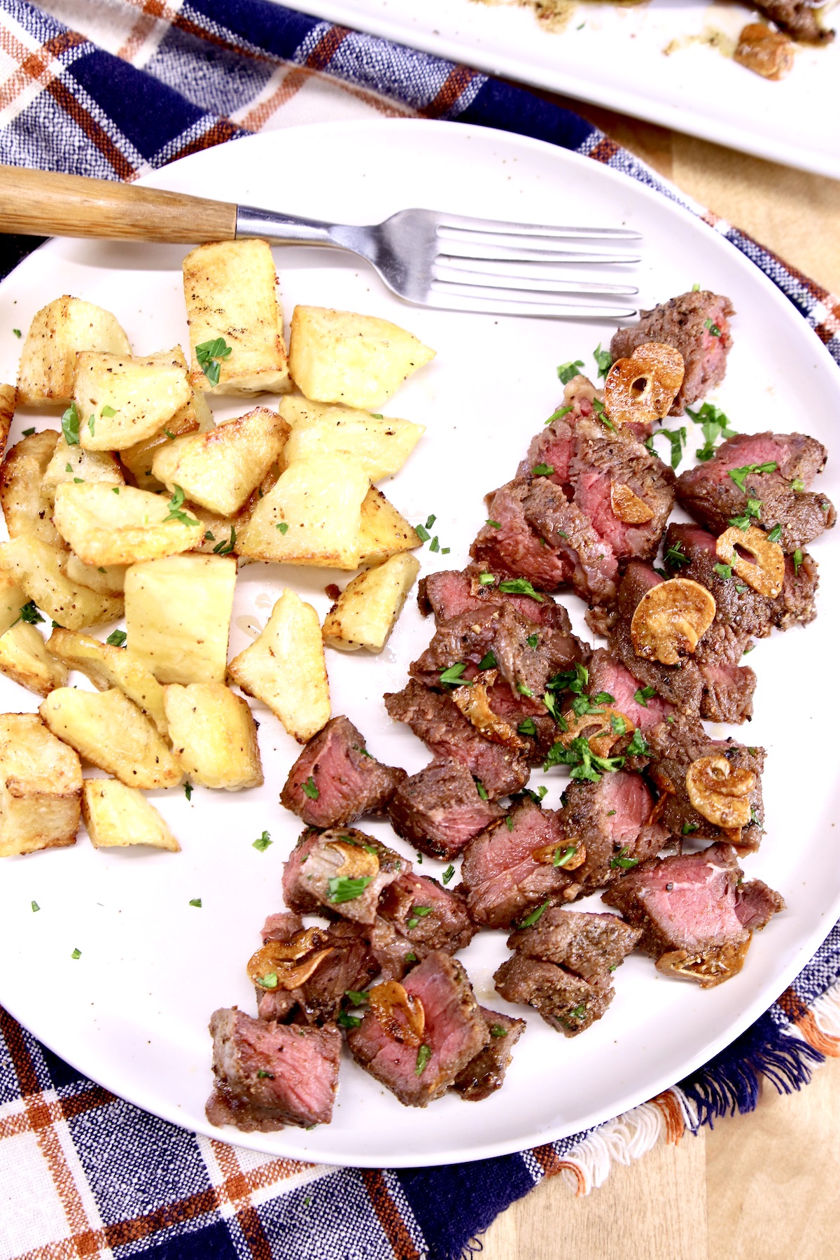 steak bites and potatoes on a plate