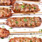 Grilled Ground Beef Kabobs on a platter - text overlay