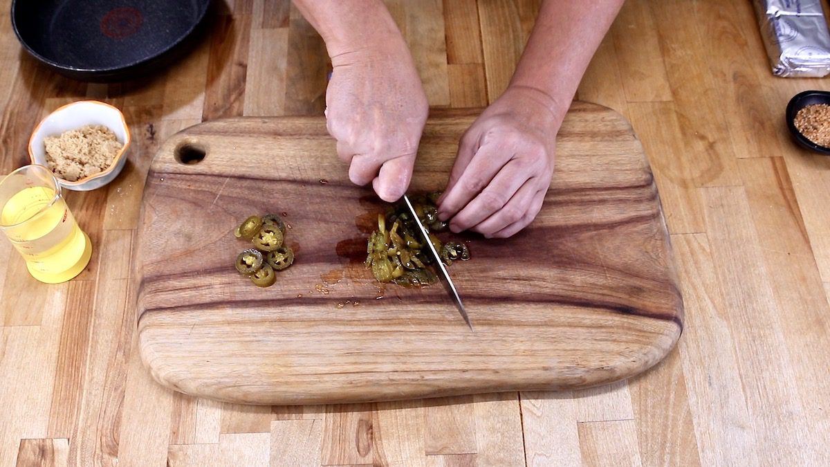 dicing jalapenos on a cutting board