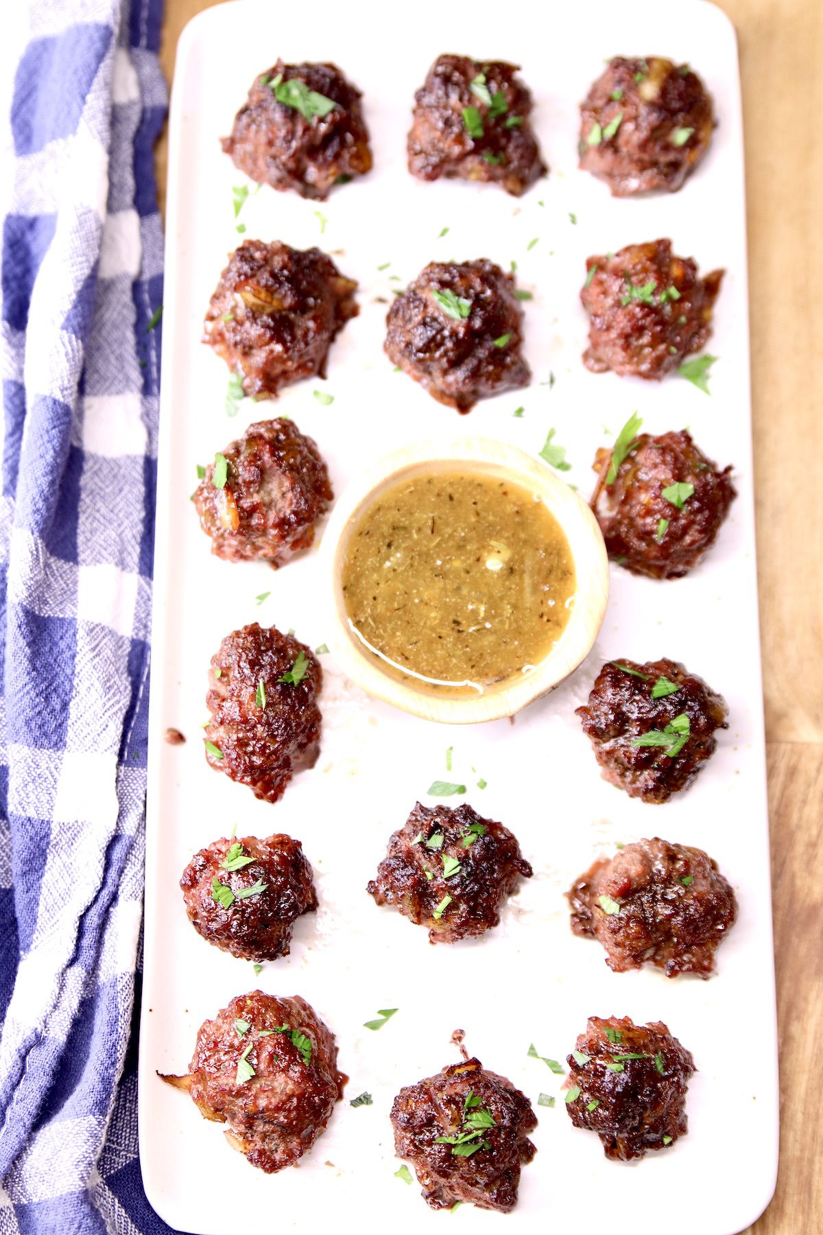 platter of meatballs with dipping sauce in center