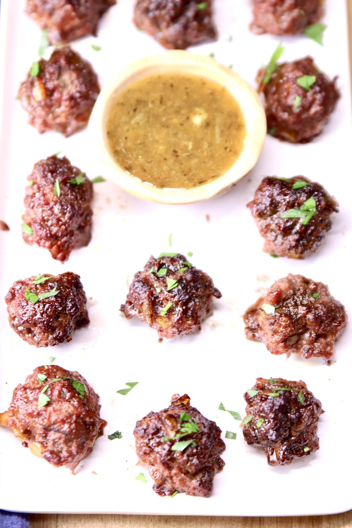 orange ginger dipping sauce on a platter with meatballs