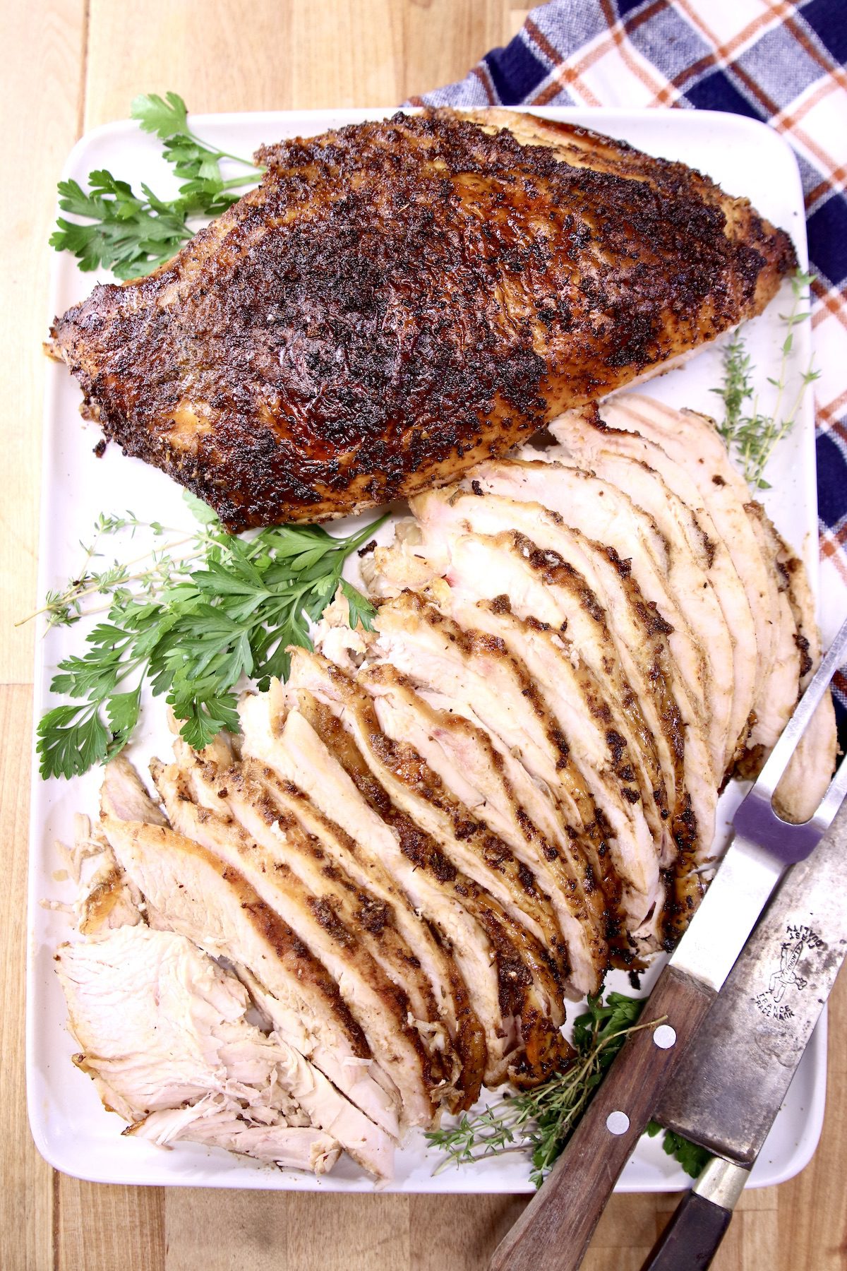 Turkey breast on a platter, half sliced