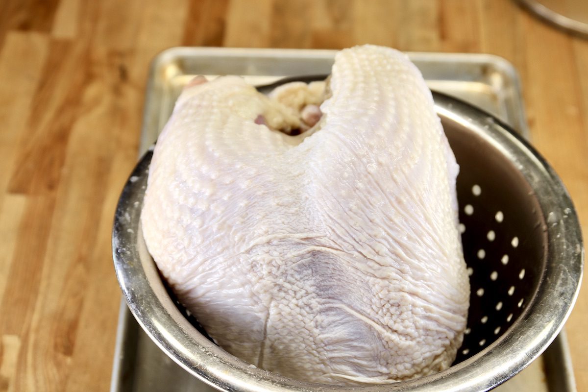 draining a brined turkey breast in a colander