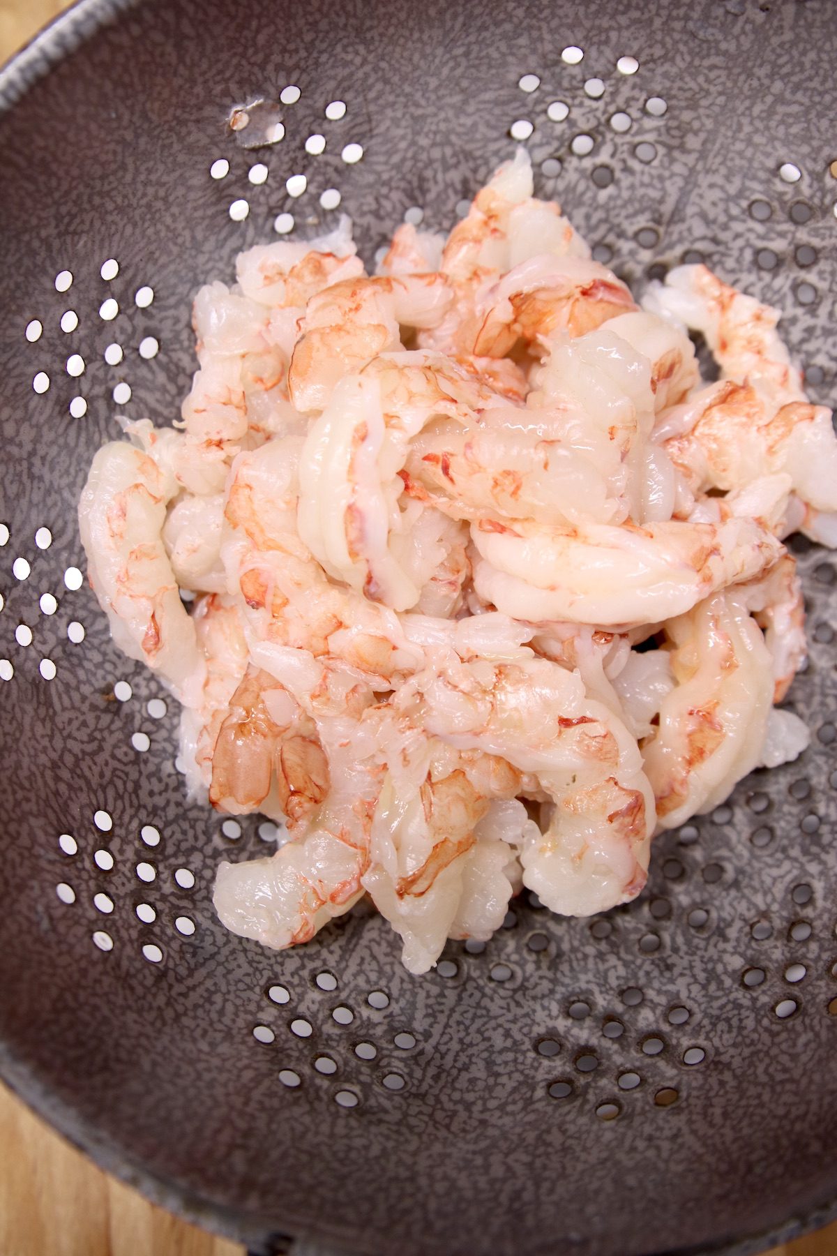 peeled shrimp in a colander