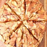 apple pie pizza - overhead view, sliced on a cutting board, text overlay