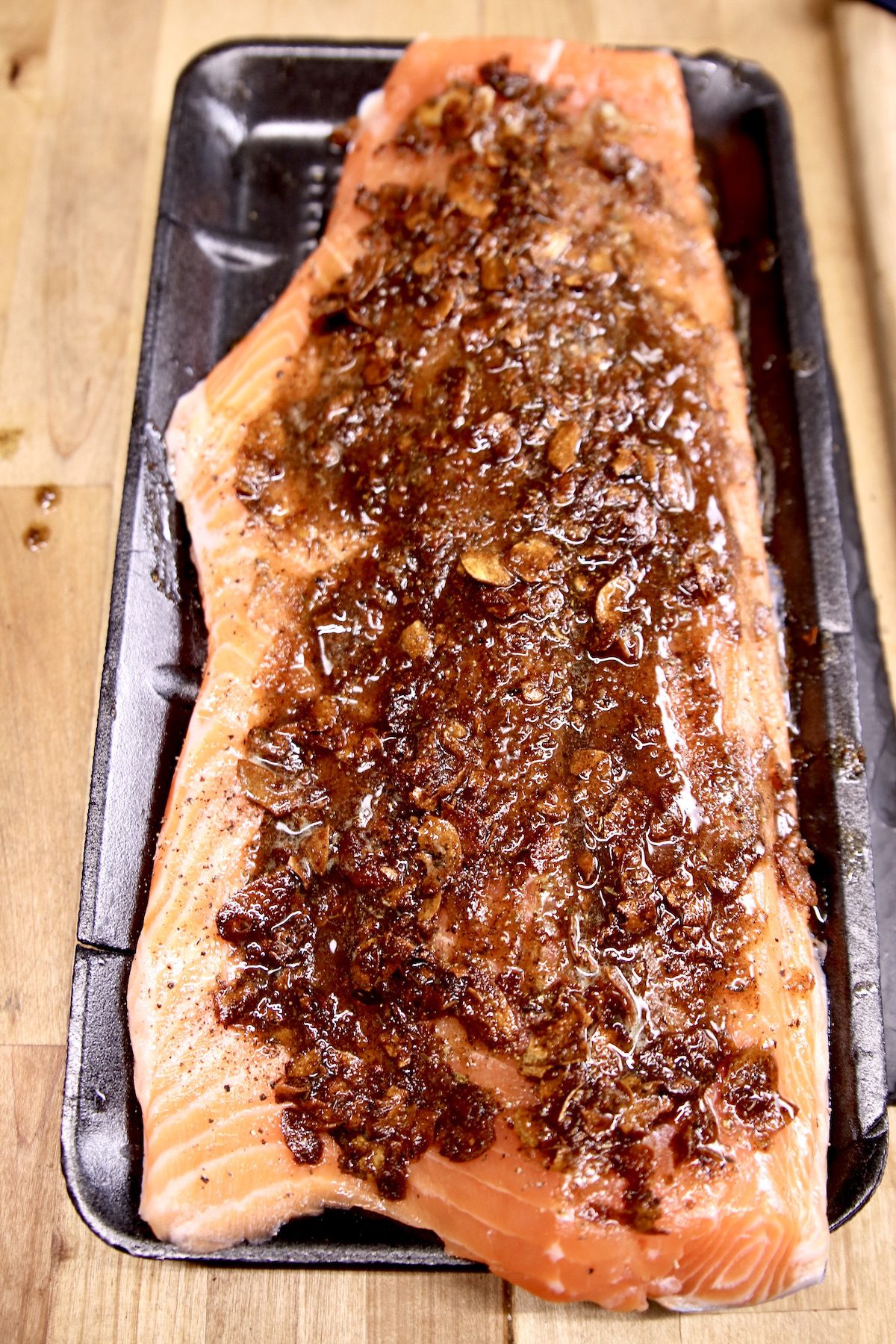 garlic butter coated salmon fillet ready to grill