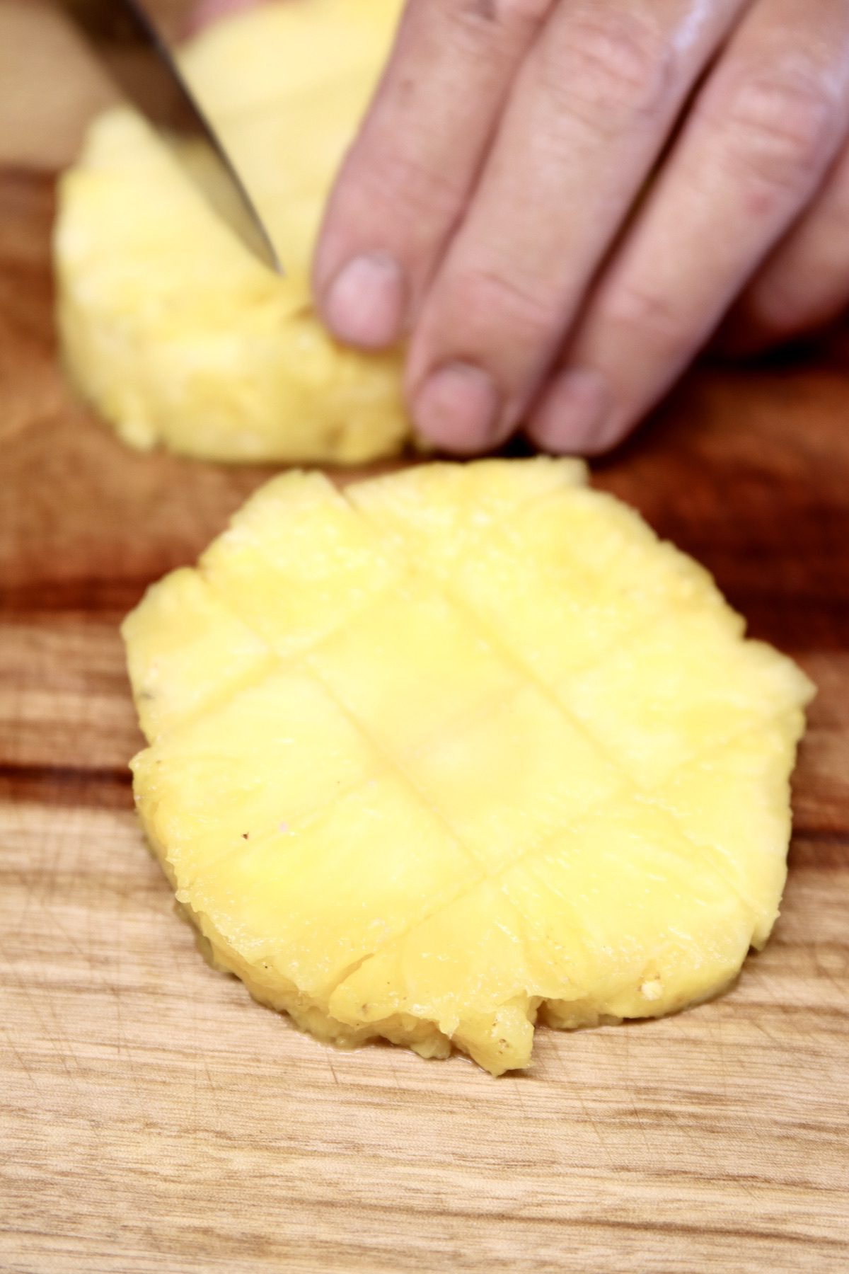 cutting pineapples into chunks