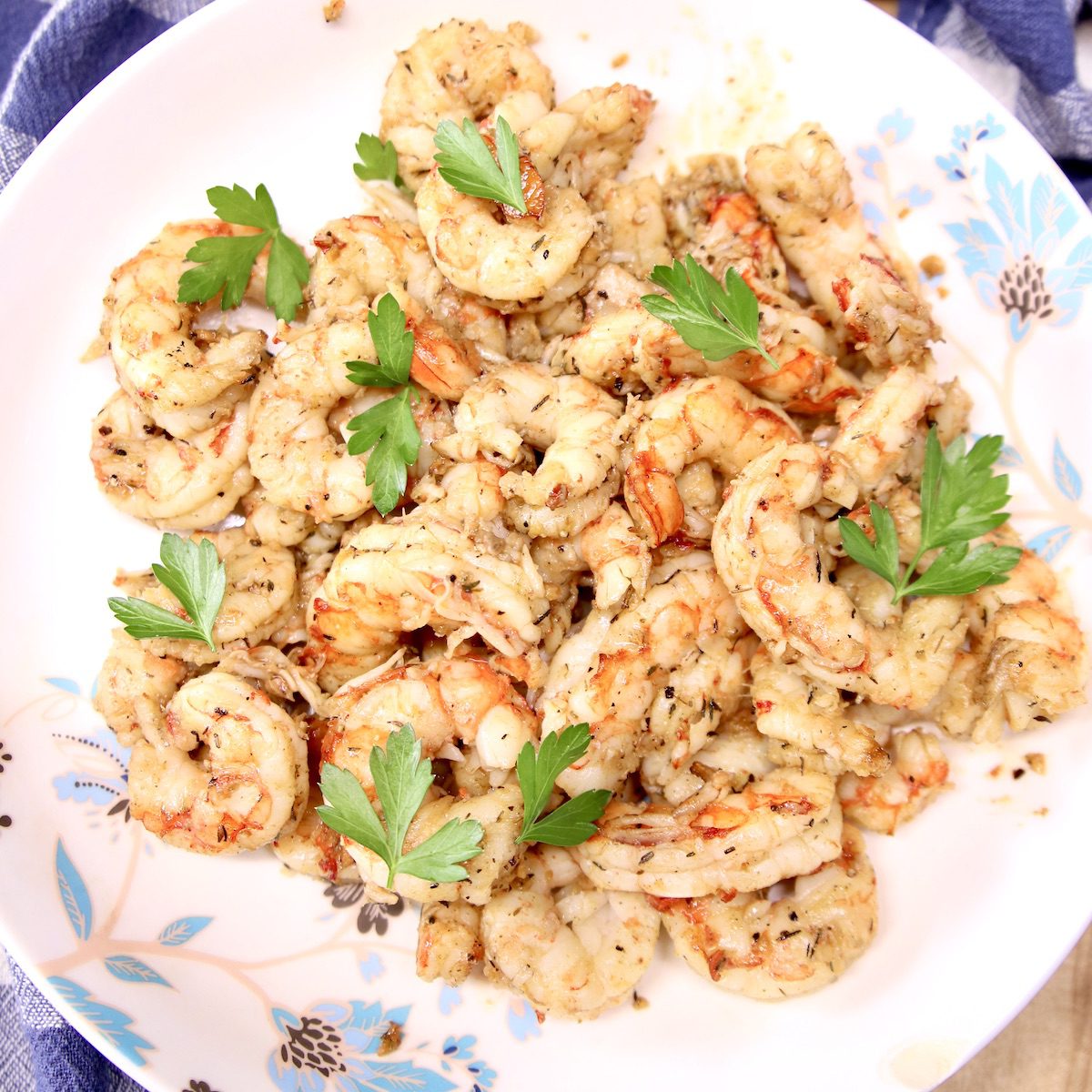 bowl of grilled garlic butter shrimp with parsley