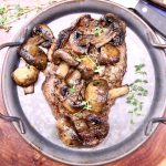 Grilled strip steak topped with sauteed mushrooms