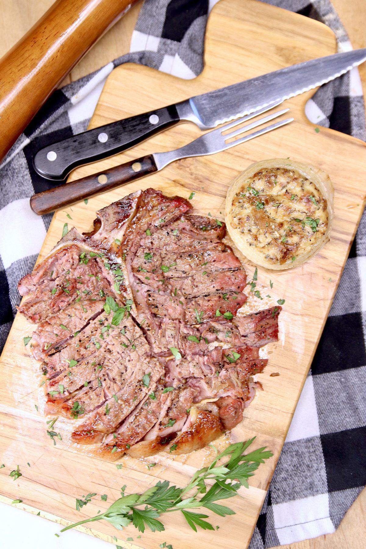 steak and stuffed onion on a cutting board