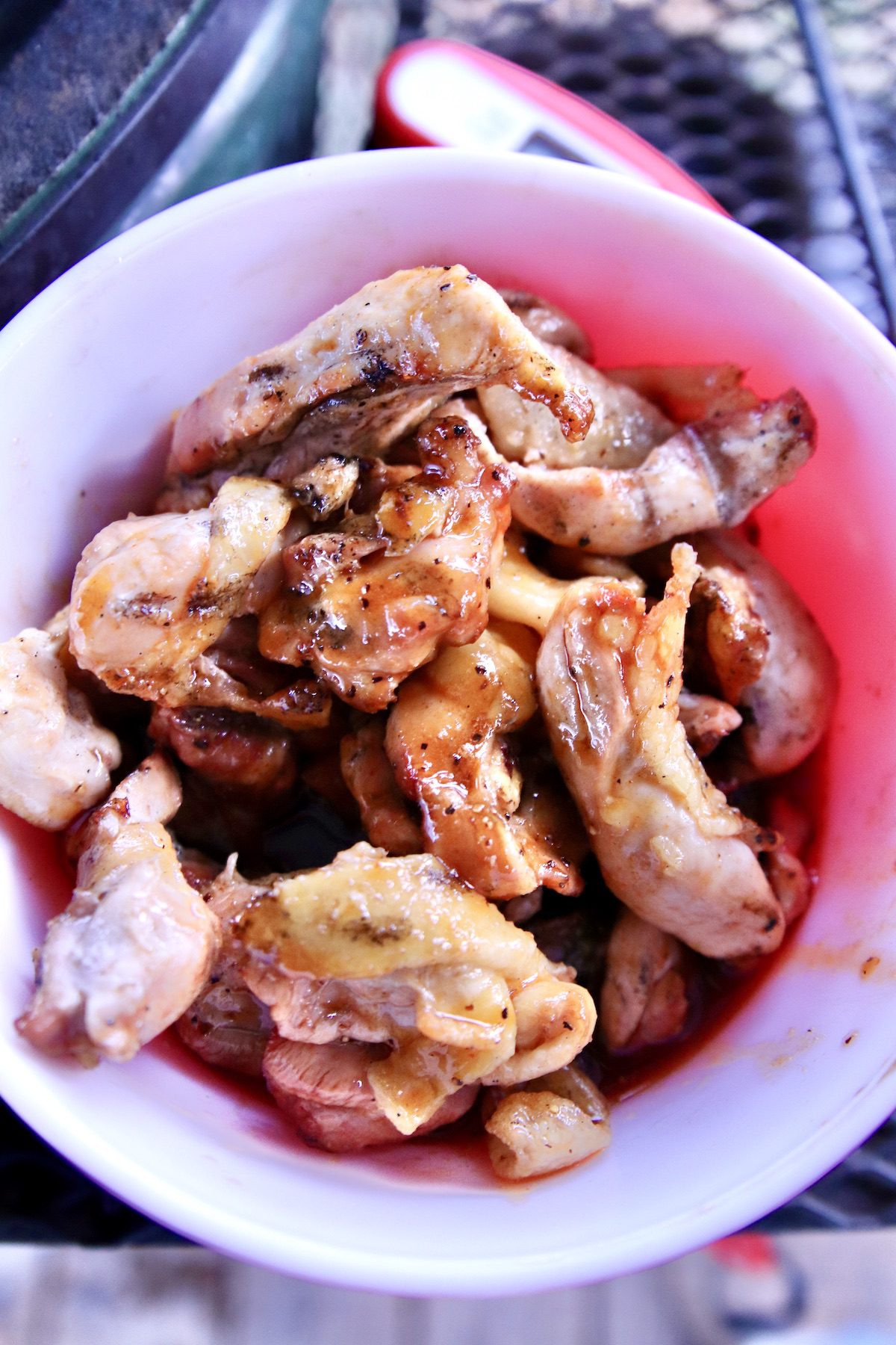chicken wings tossed in sauce in a bowl