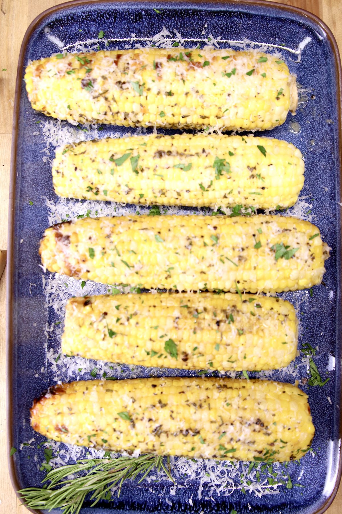 Platter of 5 ears of corn on the cob with herb butter