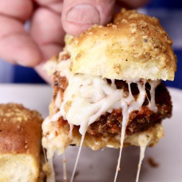 closeup of pizza burger slider - in hand