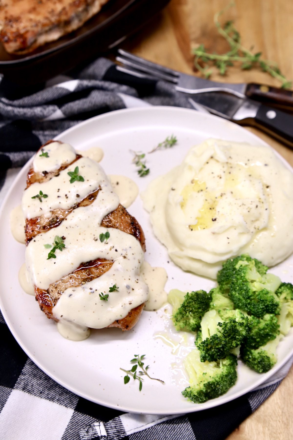 plate with pork chop, mashed potatoes, broccoli