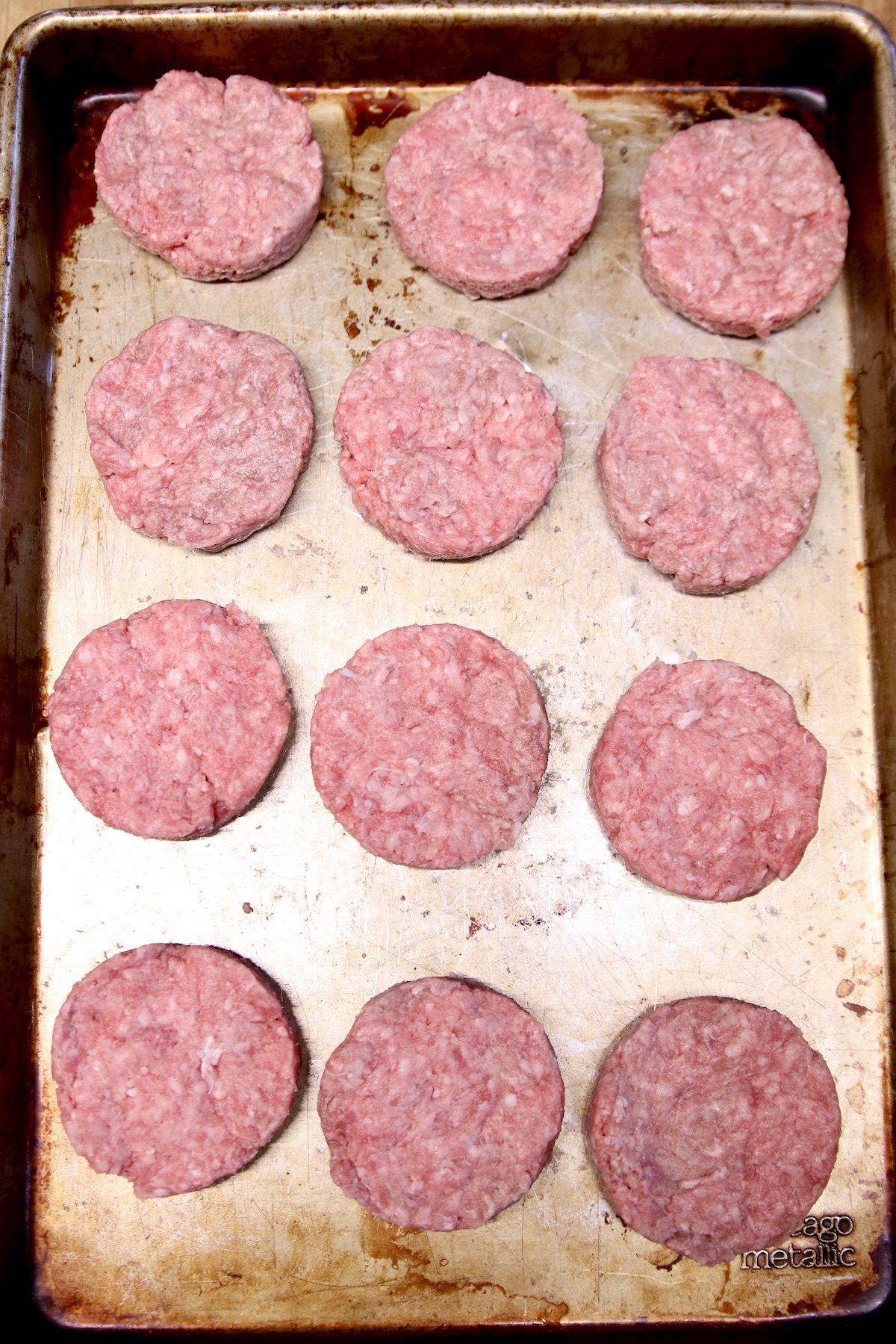 12 mini burger patties on a sheet pan